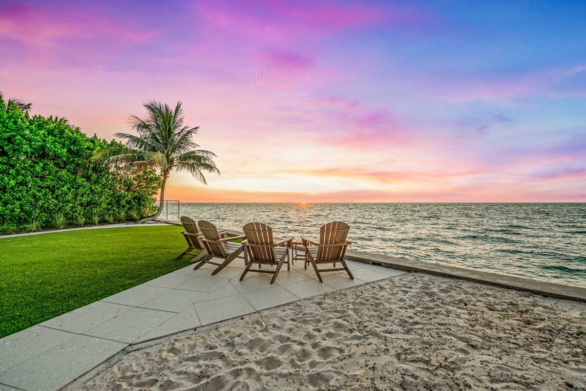 siesta key vacation rental with beach chairs at sunset